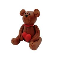 Brown teddy bear with a heart