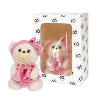 A white teddy bear with a pink dress