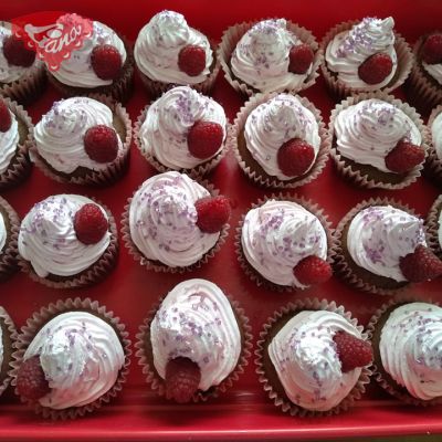 Gluten-free and dairy-free cupcakes with cherry and raspberry whipped cream