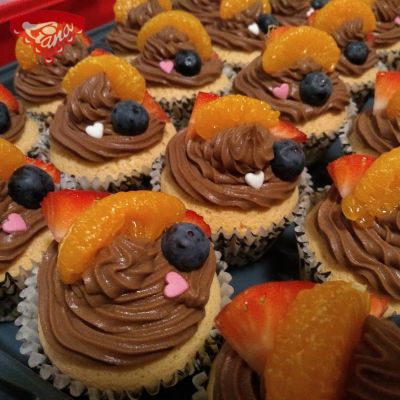 Gluten-free cupcakes with chocolate cream and fruit