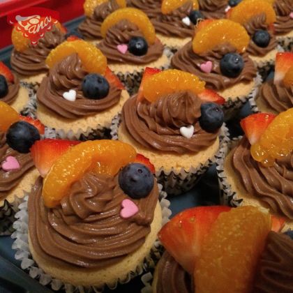 Gluten-free cupcakes with chocolate cream and fruit