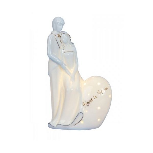 Newlyweds in the embrace of a porcelain statuette