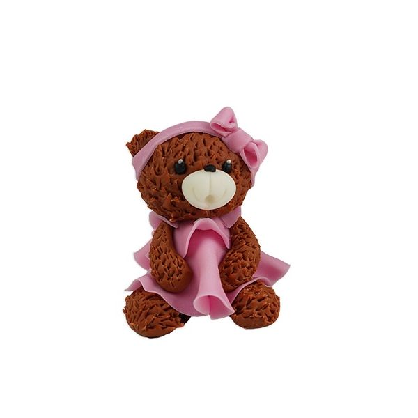 A brown teddy bear with a pink dress