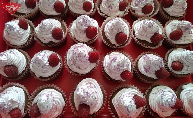 Gluten-free and dairy-free cupcakes with cherry and raspberry whipped cream Gluten-free and dairy-free cupcake with cherry and raspberry whipped cream