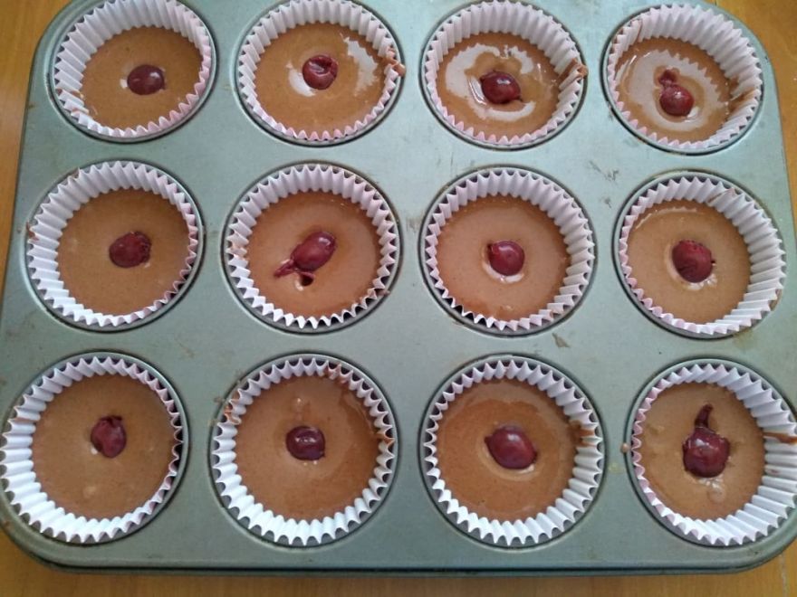 Gluten-free and dairy-free cupcakes with cherry and raspberry whipped cream